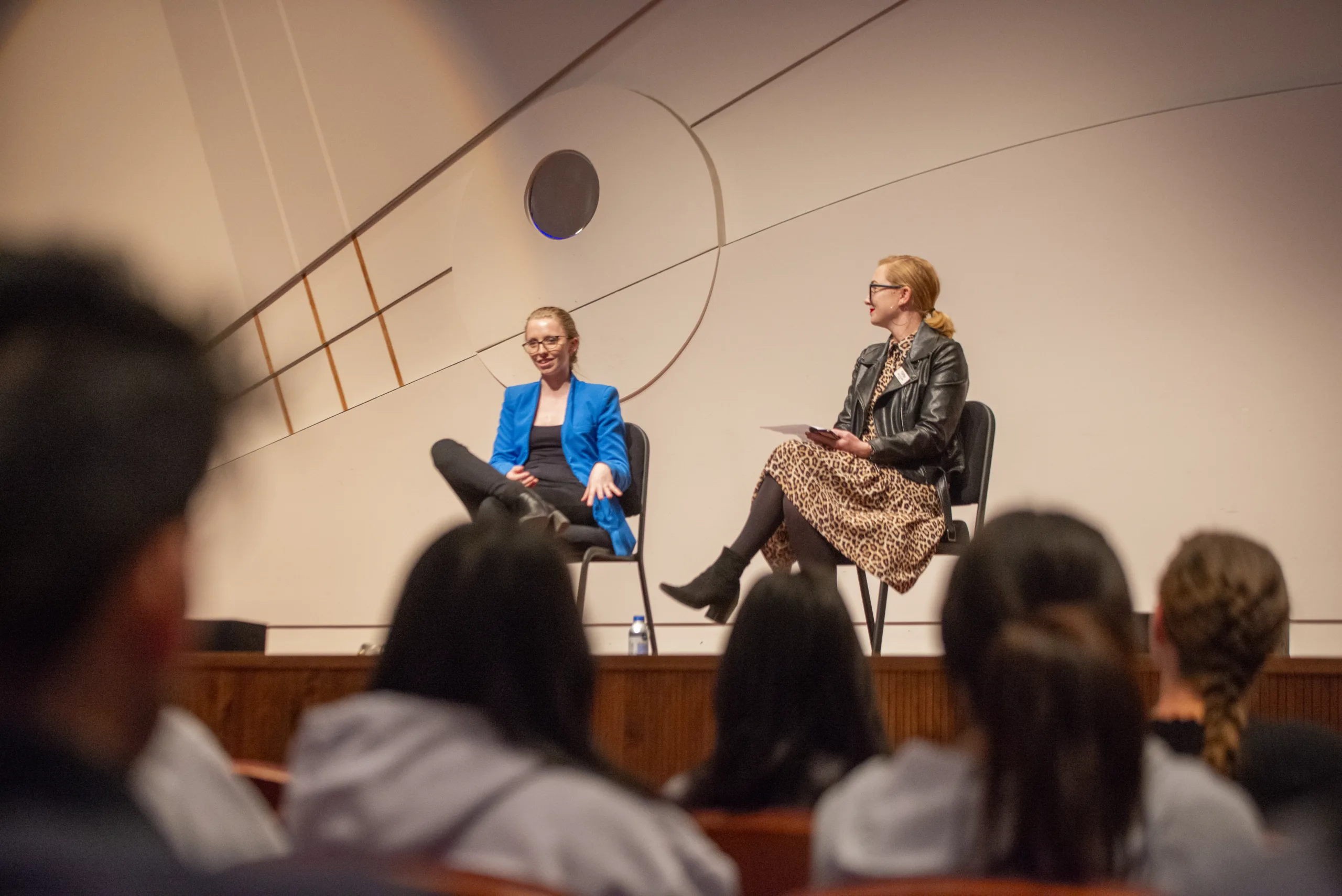 Two speakers on a stage at a public event