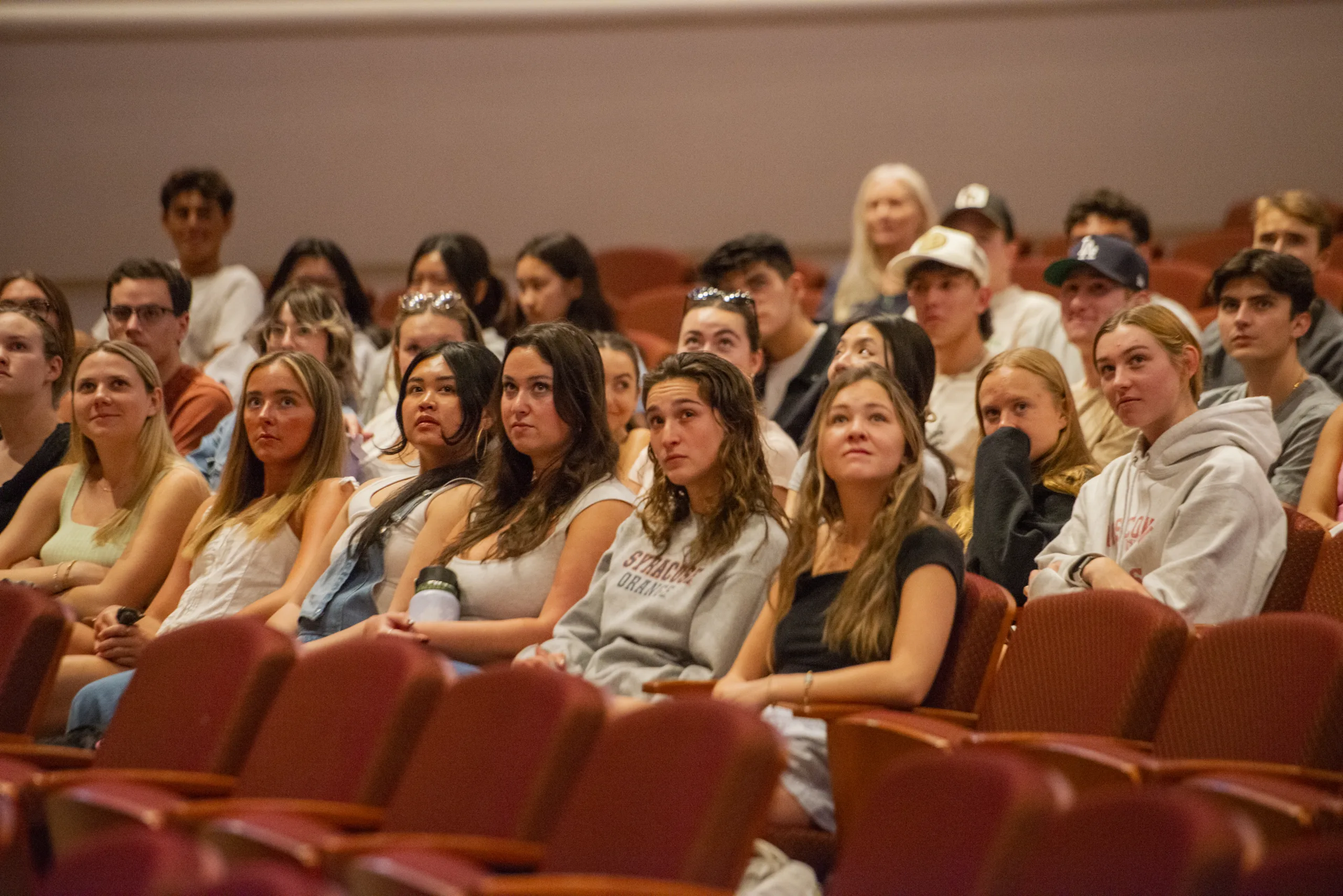 An engaged crowd watches an organist perform