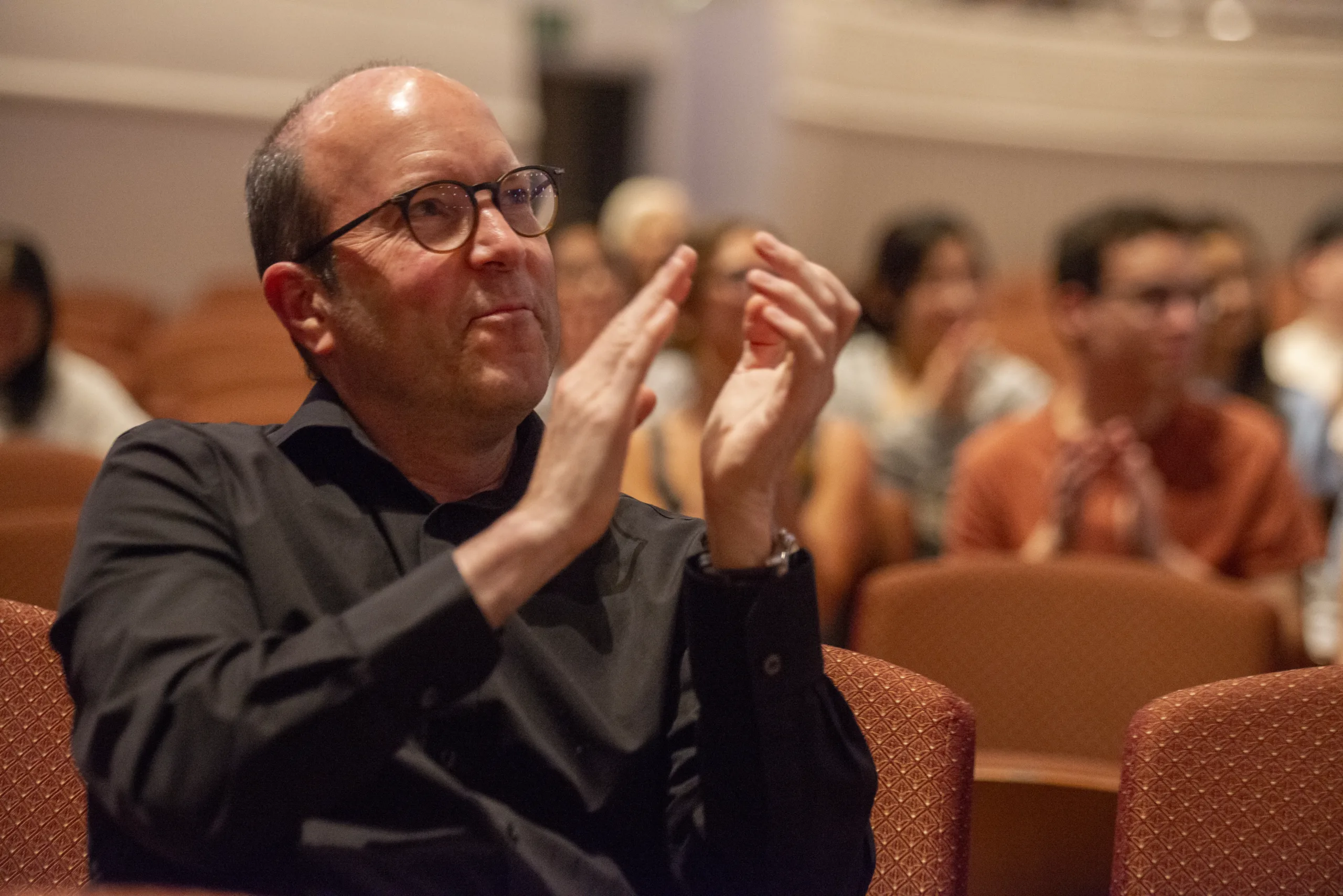 A member of an audience claps during a presentation