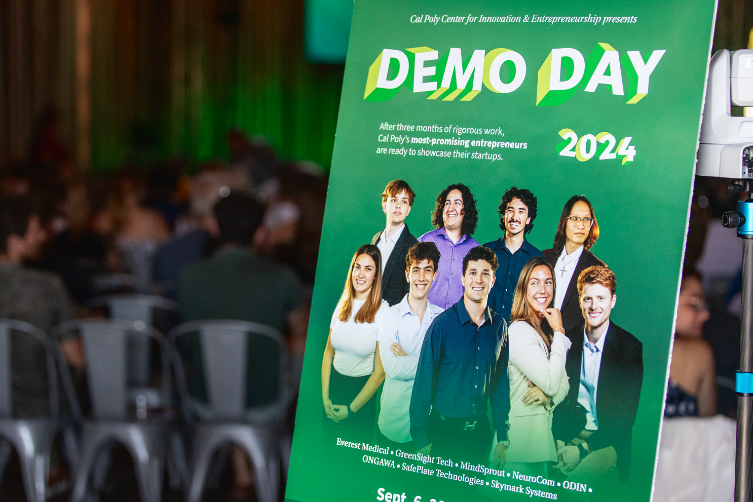 A poster announces Demo Day outside the event