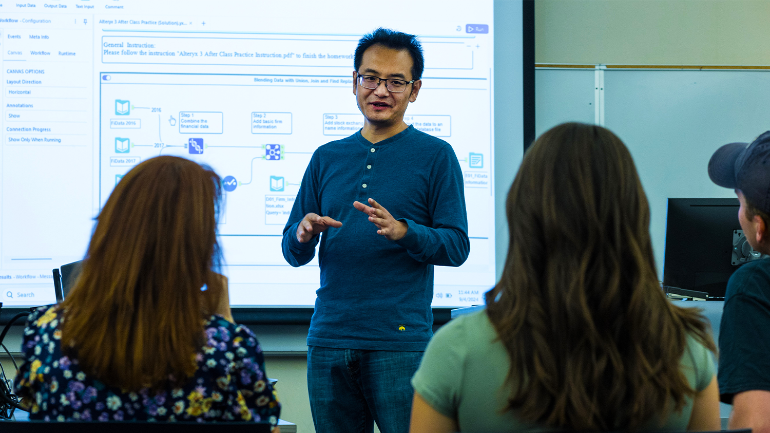 A professor demonstrates software in front of a class