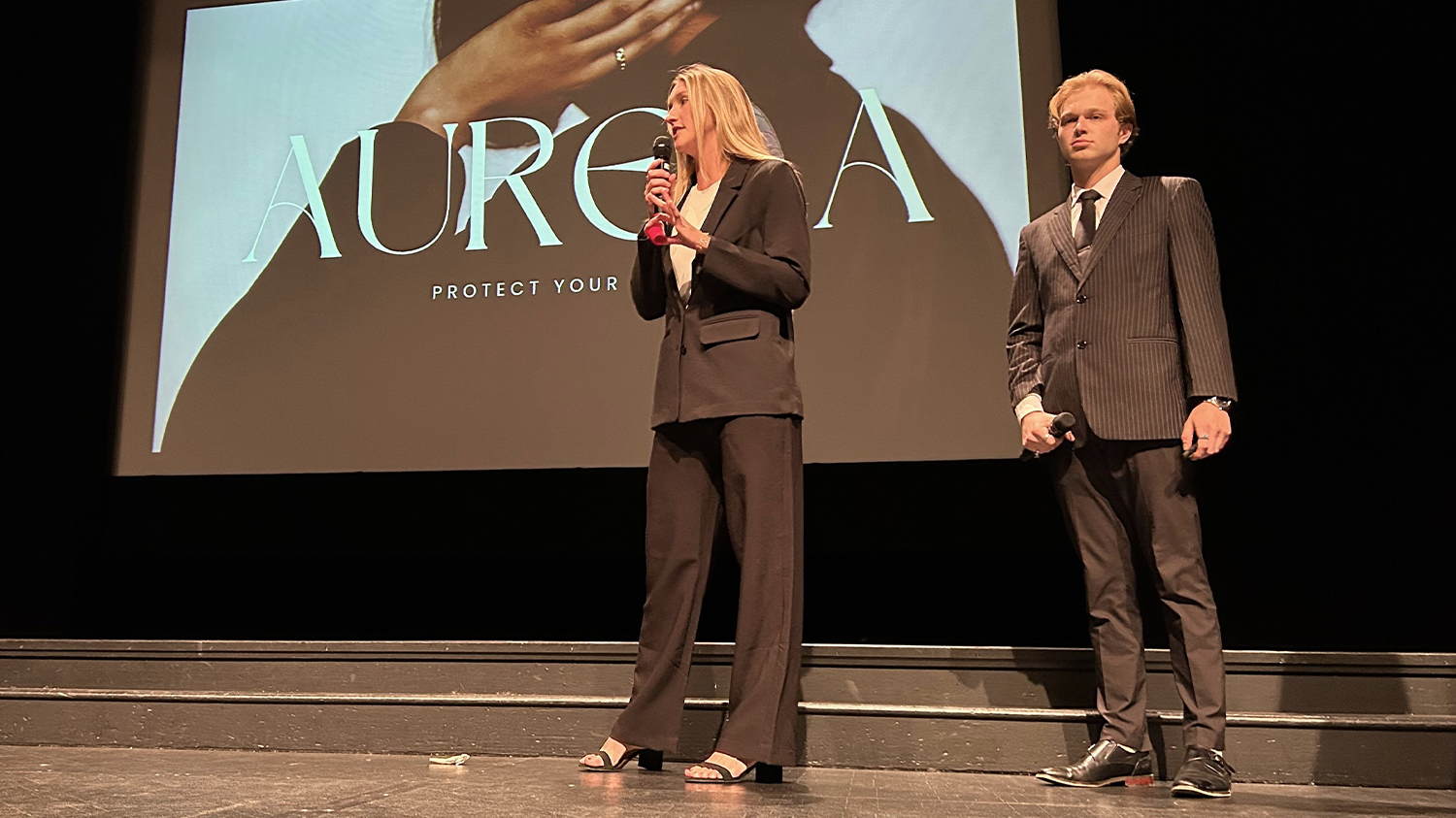 Students offer a presentation for a startup on a stage