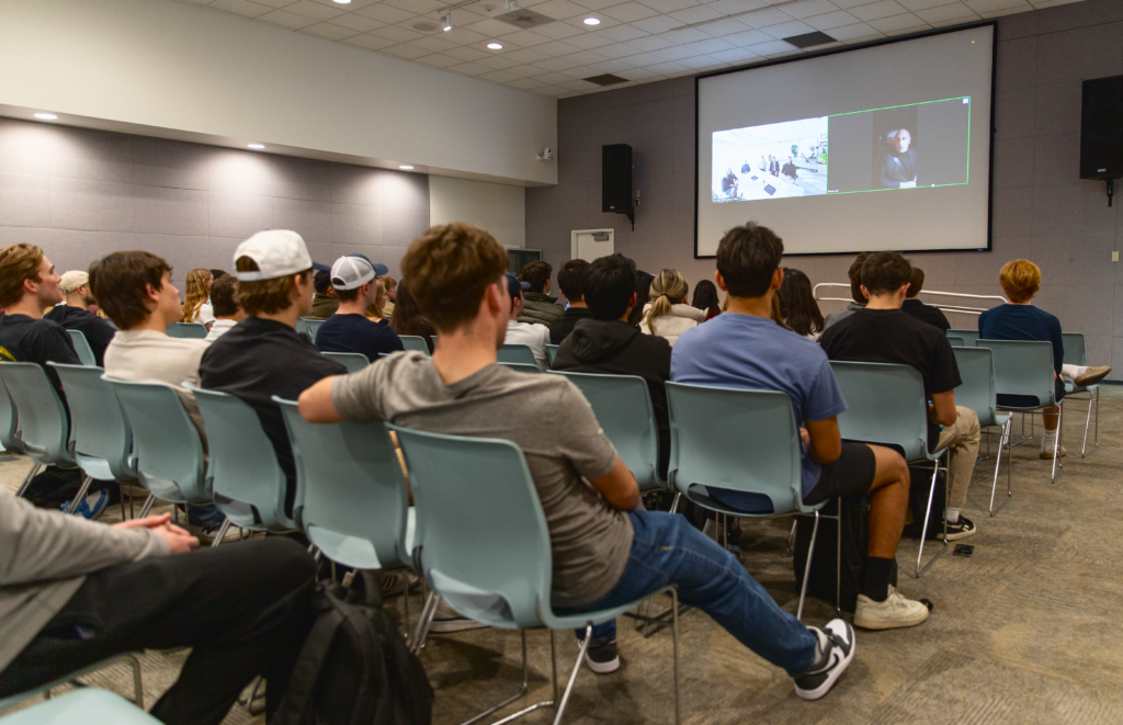 A crowd of students watches a virtual chat with Marc Lore at Cal Poly