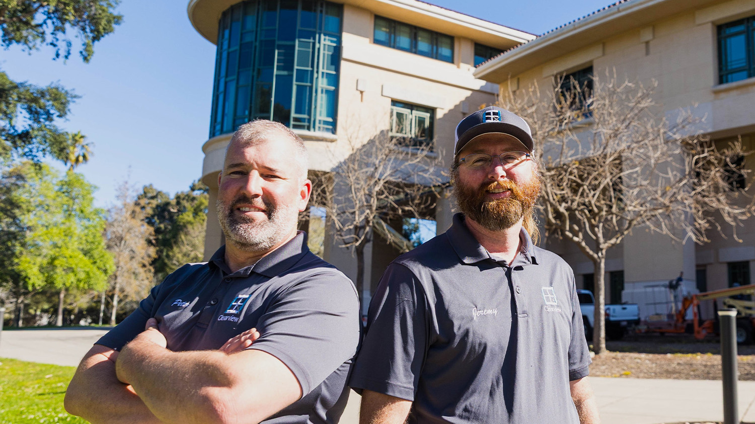 The owners of Clearview window washing pose for a portrait