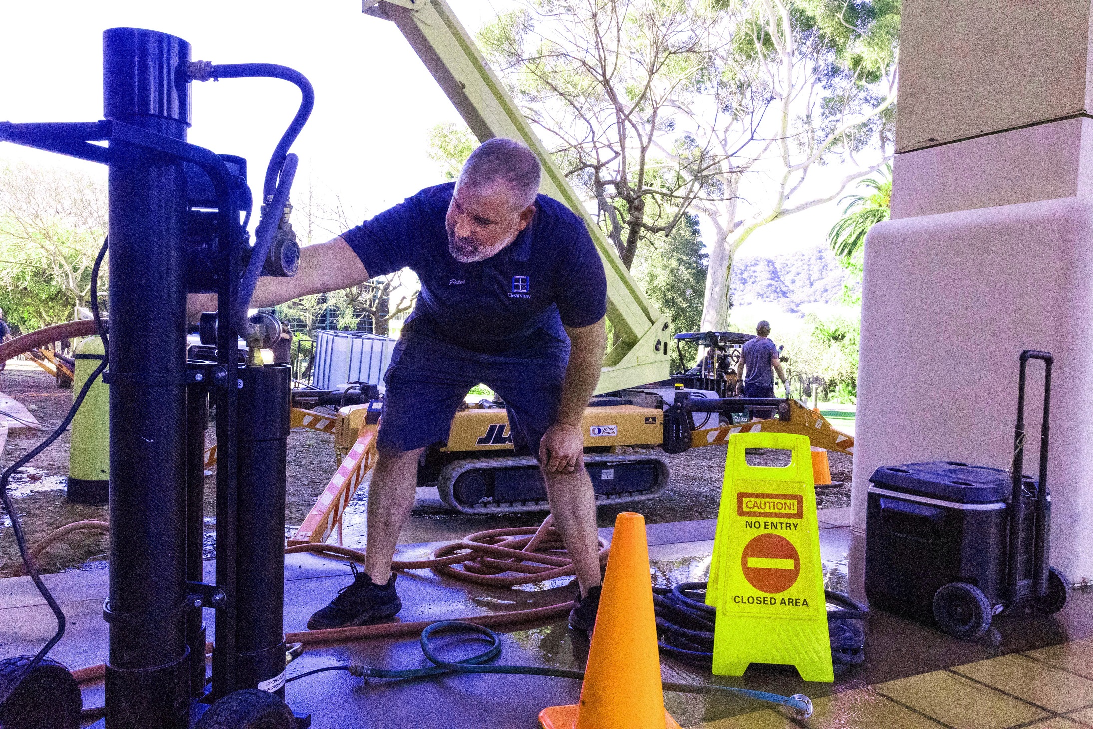 A window washer prepares equipment for the job