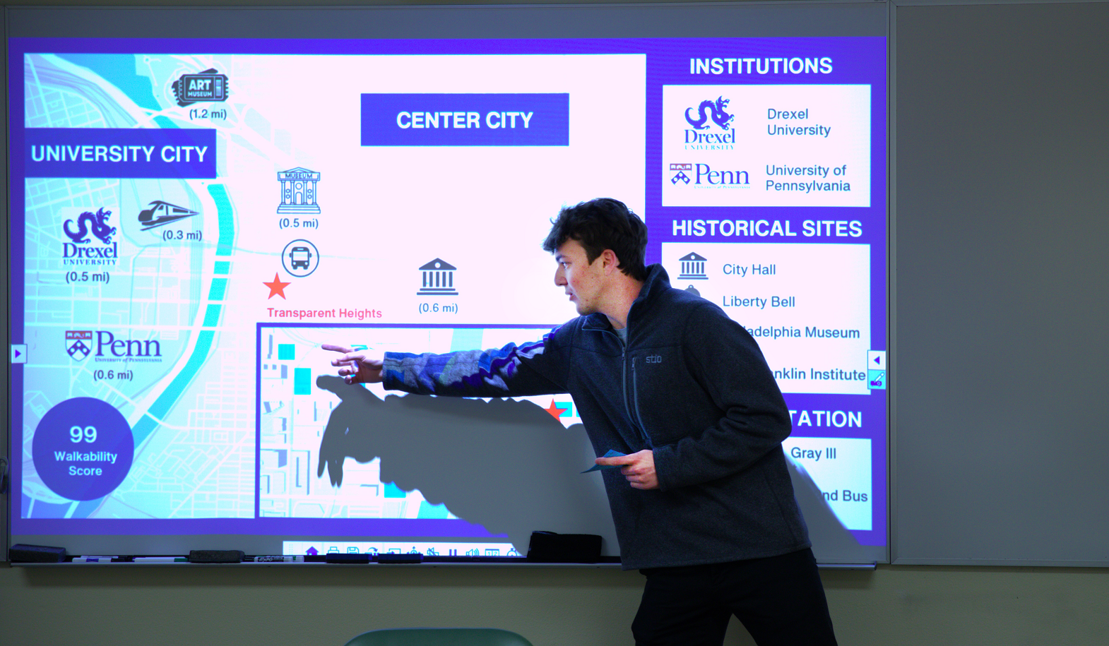 A student points out a slide show