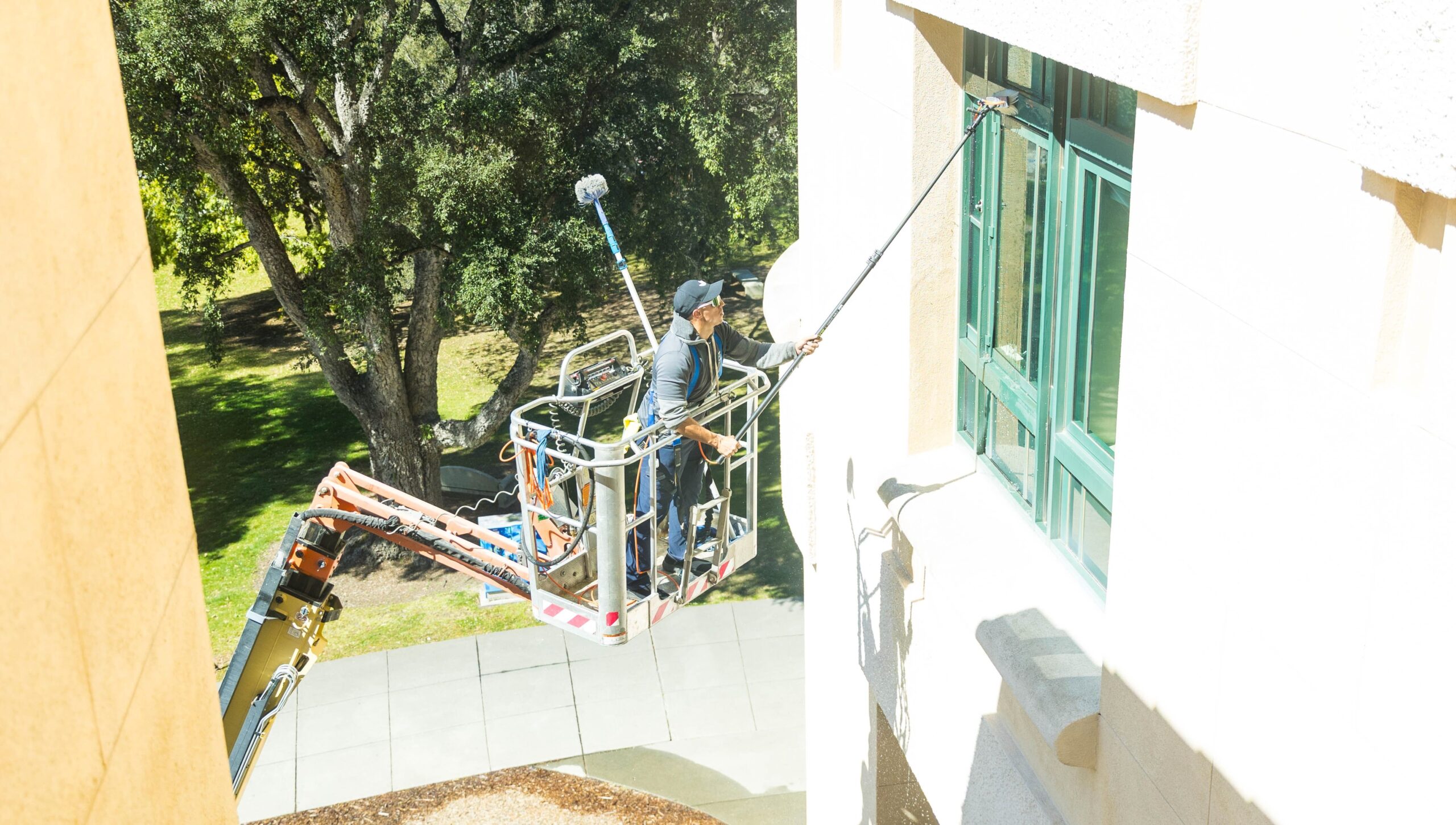 A worker uses a lift to wash windows