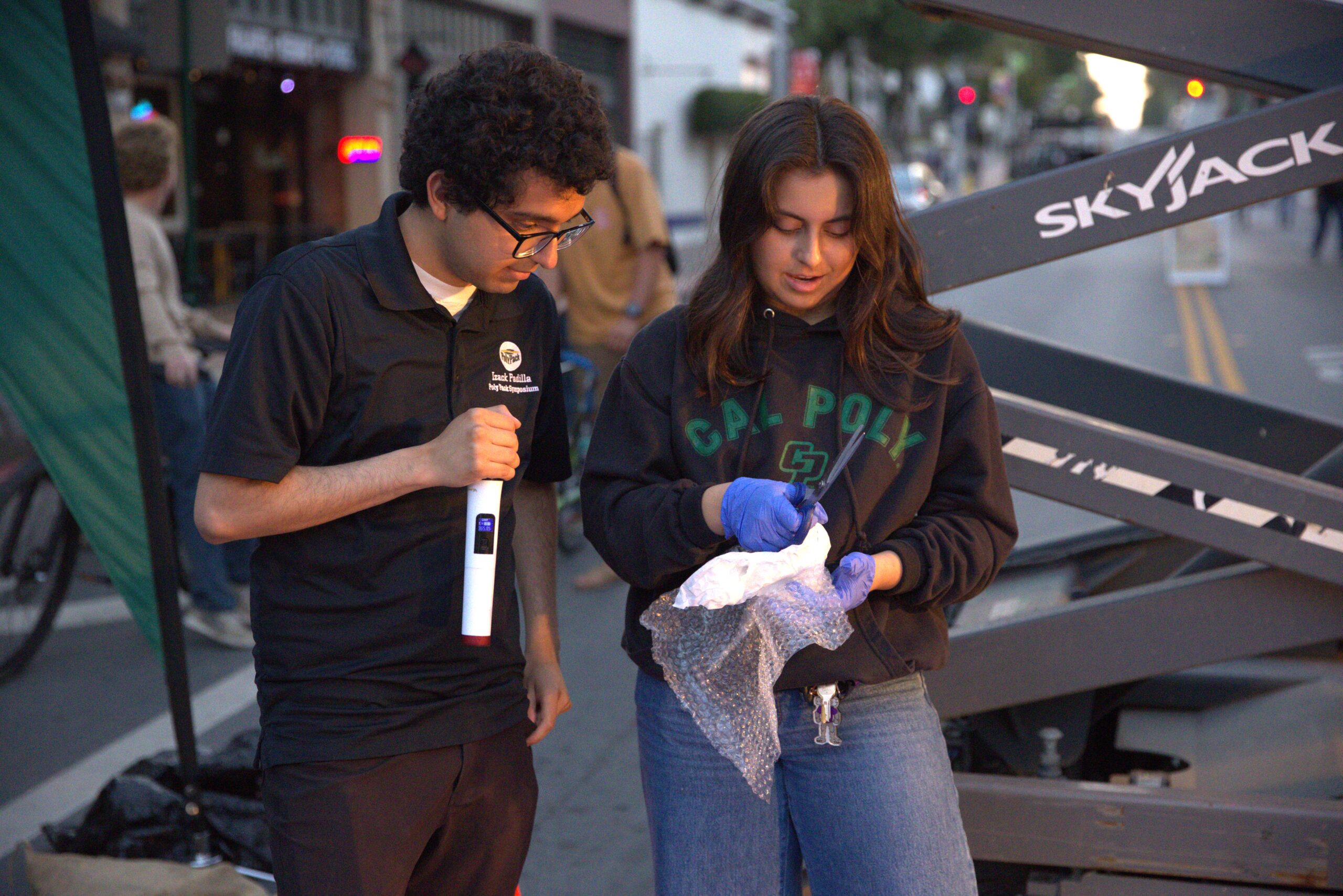 Two Poly Pack students examine a package during the Egg Drop competition