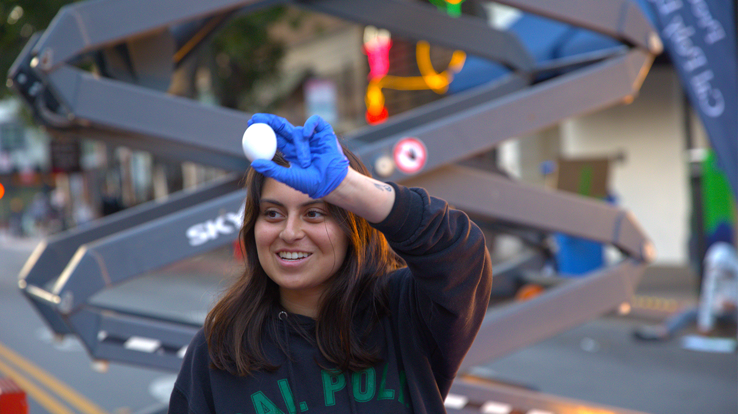 A Poly Pack member shows the crowd an intact egg