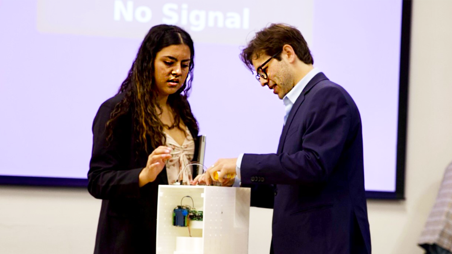 Two students demonstrate a medical device