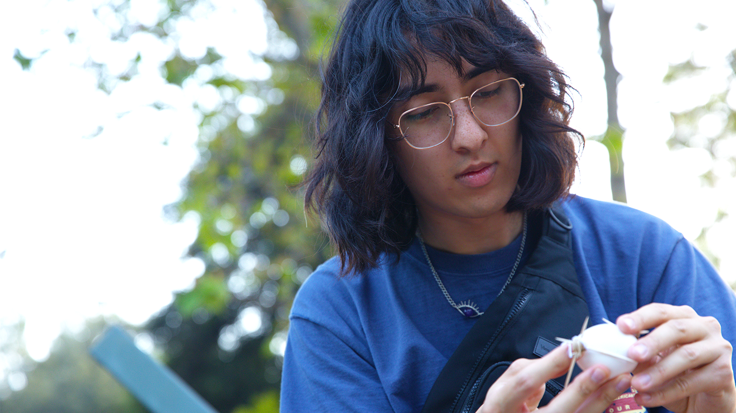 A student creates a package for an egg, using toothpicks