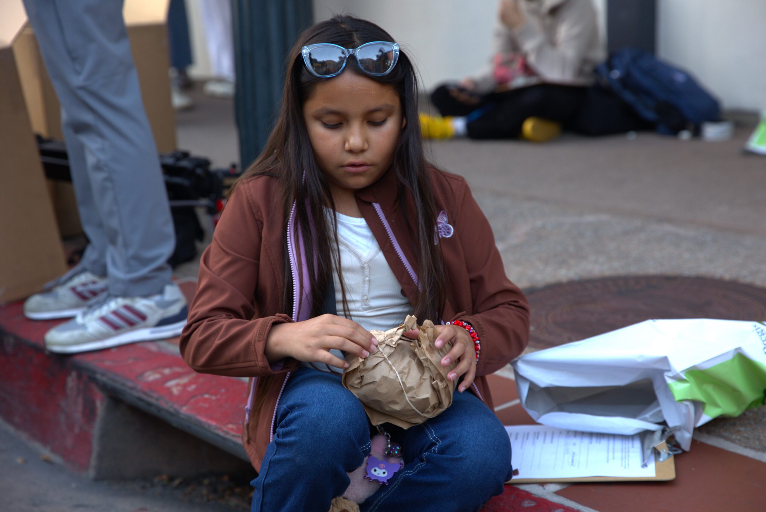 A girl creates packaging for the egg drop contest