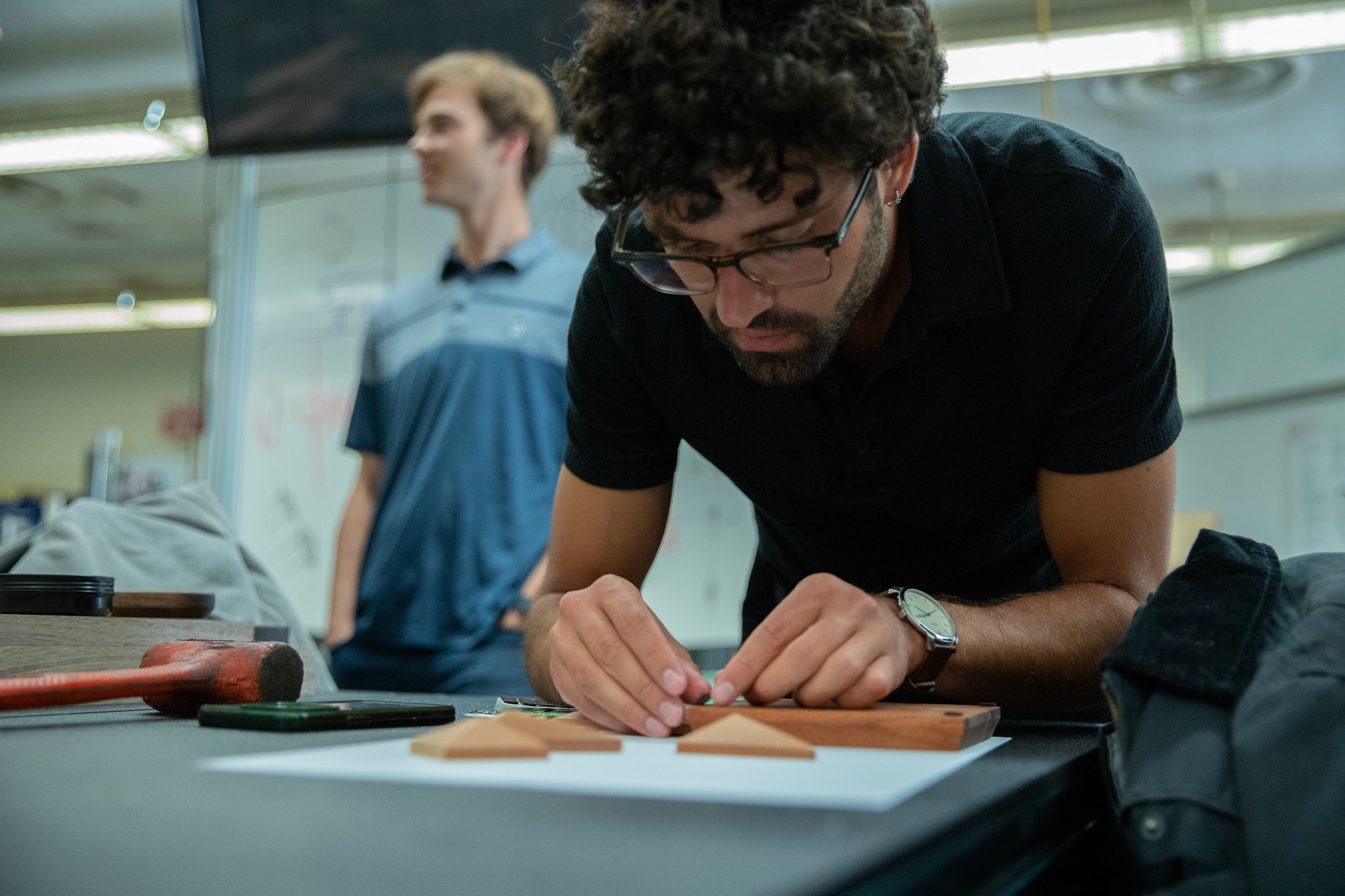 A student works on creating a puzzle in his capstone class