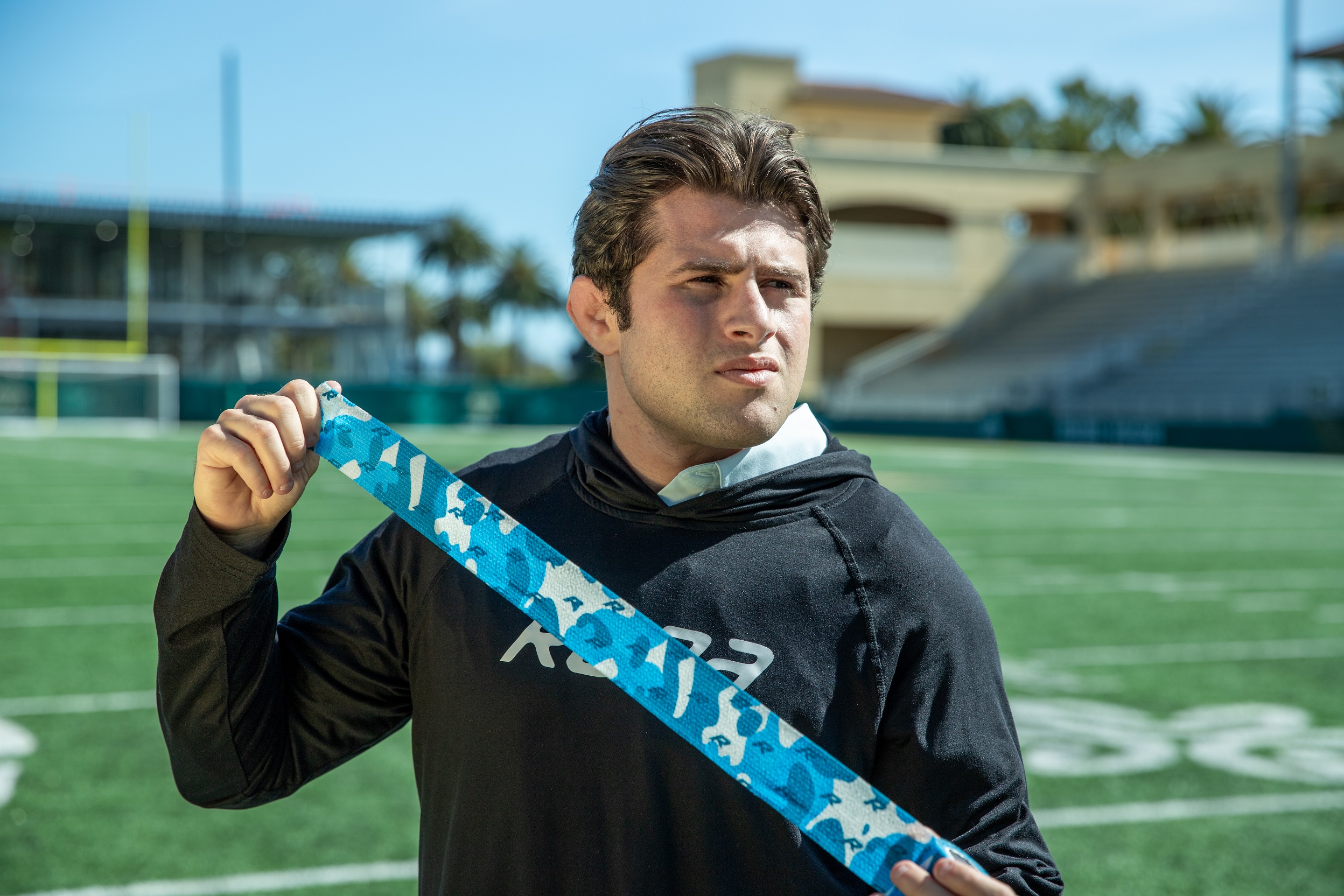 Student displaying athletic tape at the Spanos