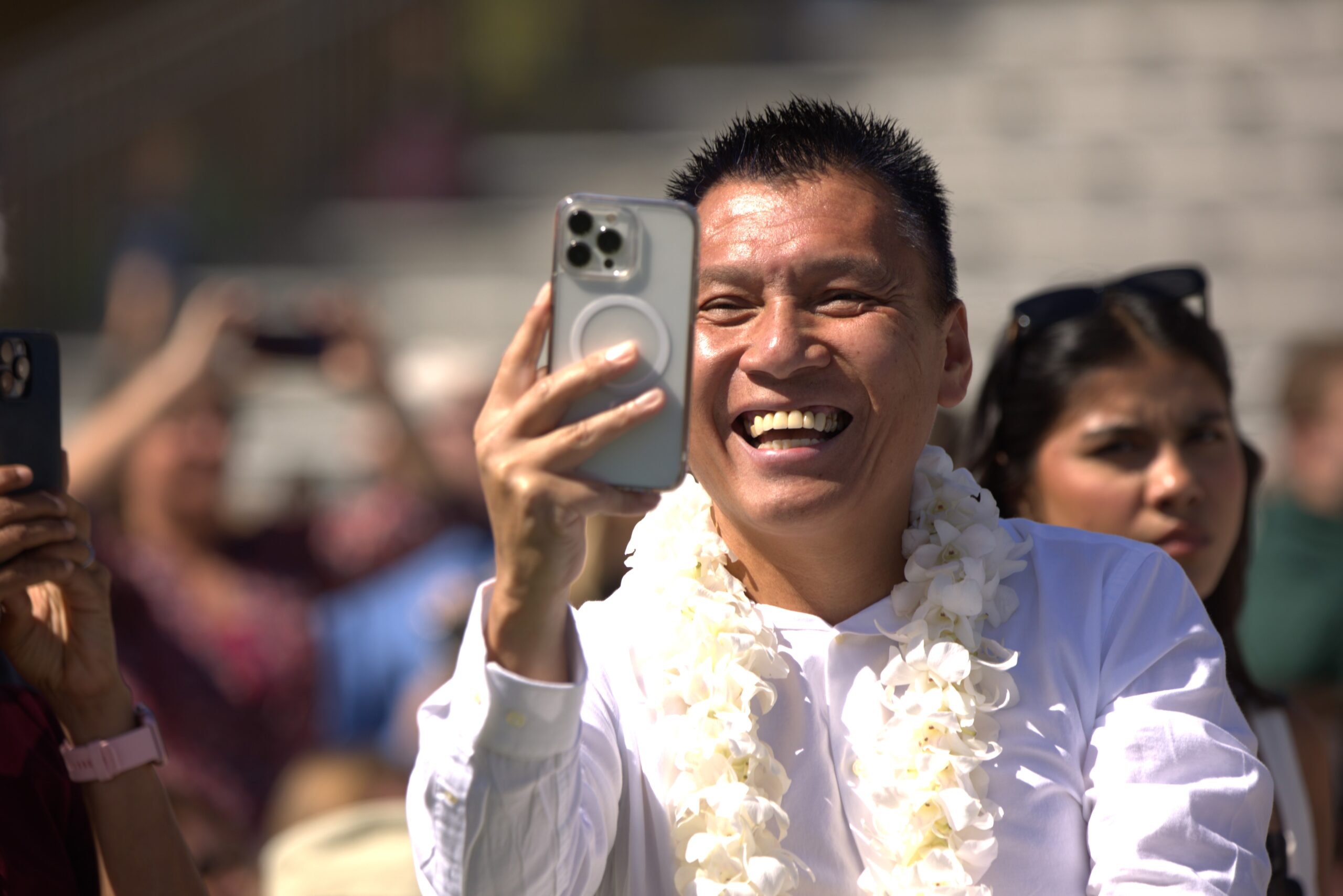 Proud family members take photos at commencement