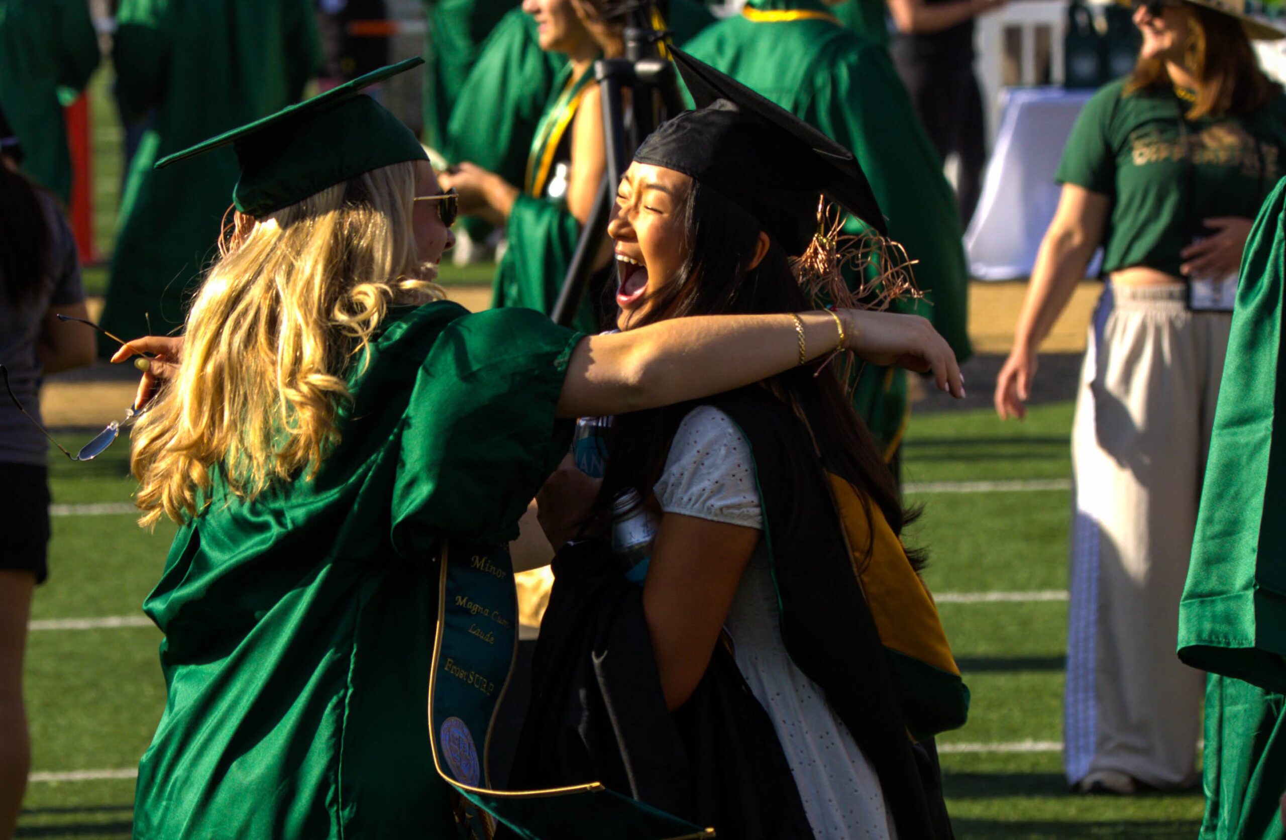 Students hug at commencement