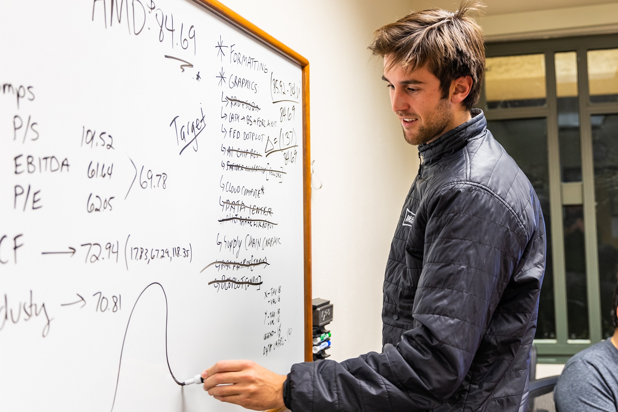 Benjamin Roe, writing on a white board